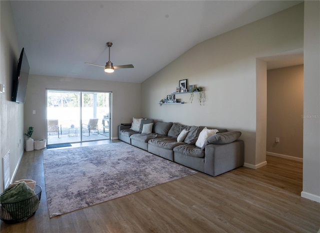 living room with hardwood / wood-style flooring, ceiling fan, and lofted ceiling