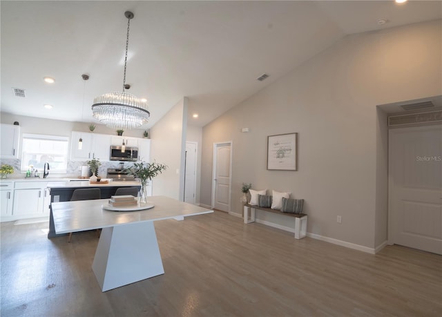 kitchen featuring pendant lighting, dark hardwood / wood-style flooring, a kitchen island, and white cabinets