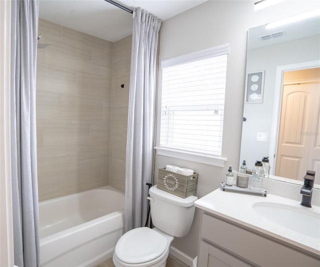 full bathroom featuring vanity, shower / bath combination with curtain, and toilet