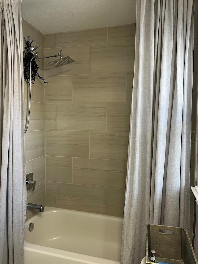 bathroom featuring shower / bath combo with shower curtain