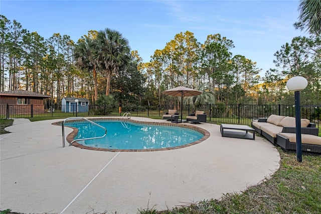 view of swimming pool featuring a patio, an outdoor hangout area, and a shed