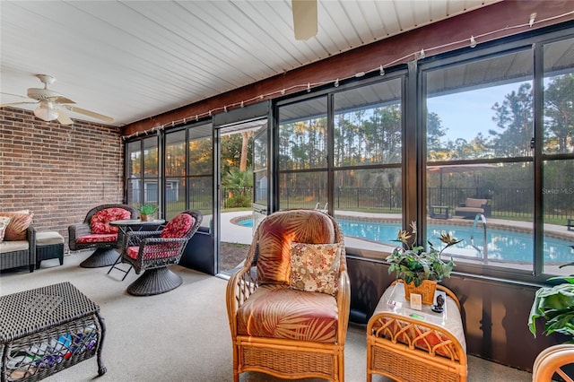 sunroom featuring plenty of natural light and ceiling fan