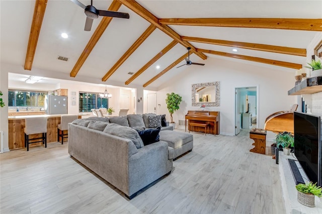 living room featuring high vaulted ceiling, ceiling fan with notable chandelier, light hardwood / wood-style floors, and beamed ceiling