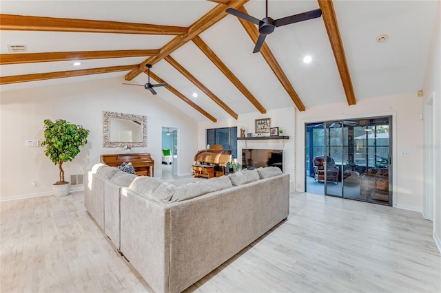 living room with beamed ceiling, light wood-type flooring, and ceiling fan