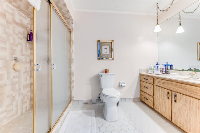 bathroom featuring crown molding, vanity, tile patterned floors, toilet, and walk in shower