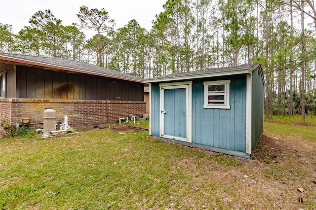 view of outbuilding featuring a lawn