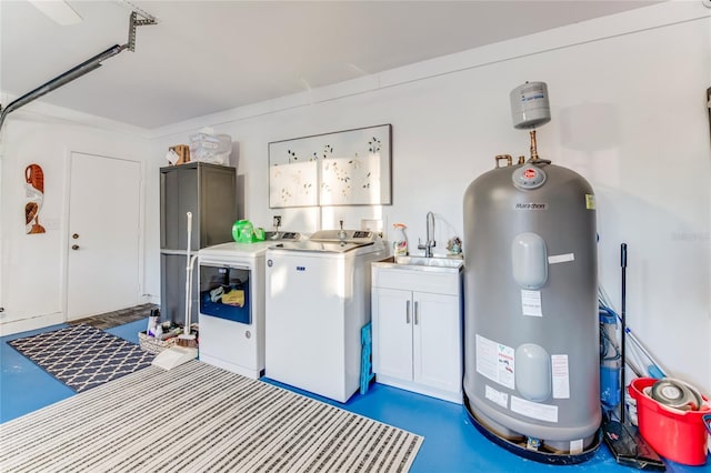 washroom featuring cabinets, sink, washer and clothes dryer, and electric water heater