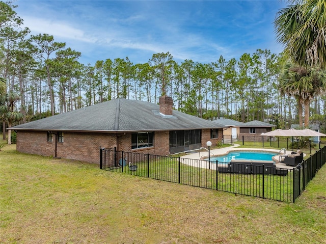 view of pool with a yard