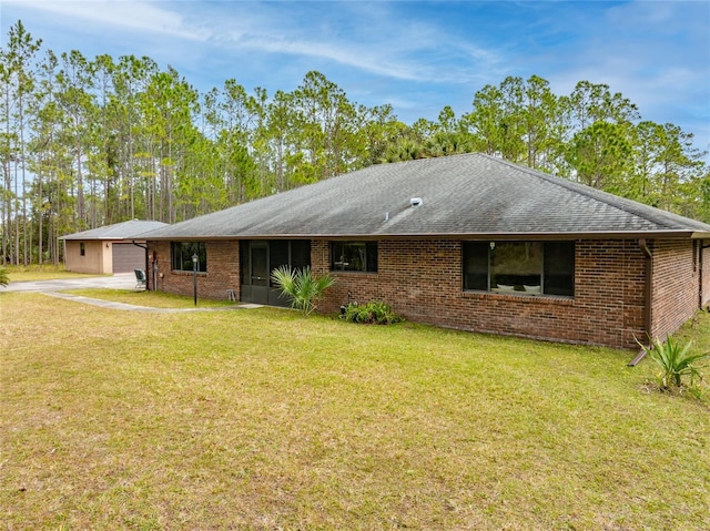 ranch-style home with a garage and a front lawn