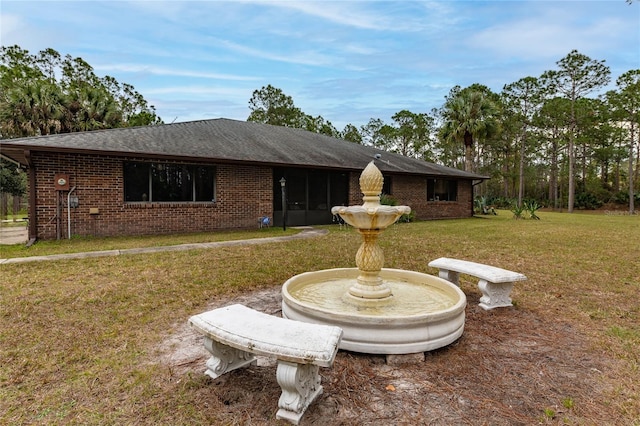 rear view of property with a yard