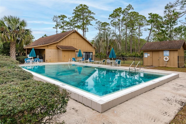 view of pool featuring a storage shed