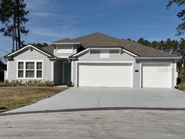 view of front of house with a garage and a front yard