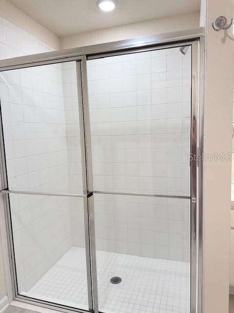 bathroom featuring a shower with door