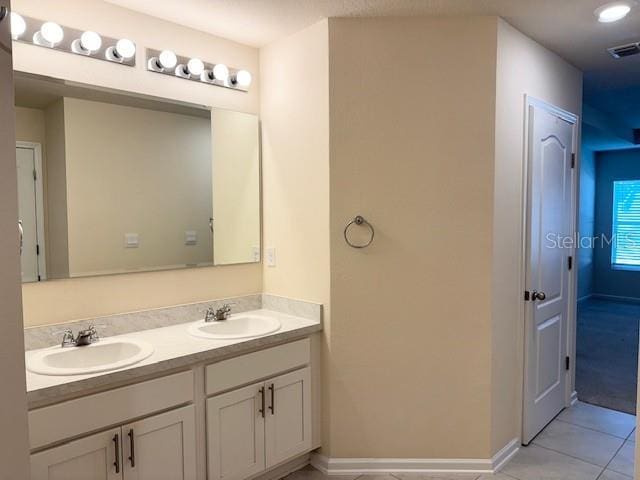 bathroom with tile patterned flooring and vanity