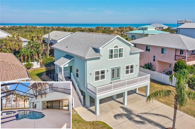 back of house with a water view, a fenced in pool, and a patio area