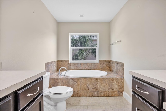 bathroom featuring vanity, toilet, and tiled tub