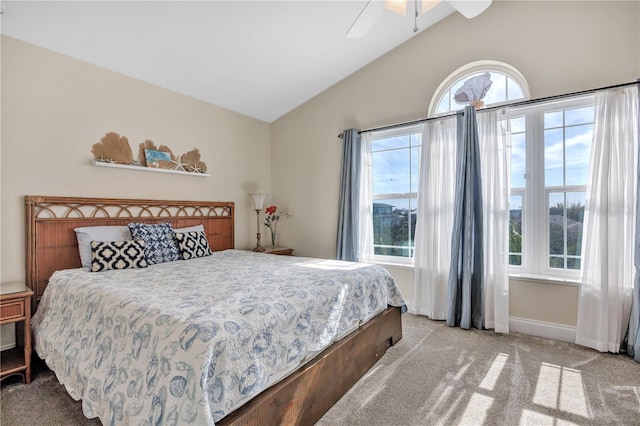 carpeted bedroom featuring ceiling fan and vaulted ceiling