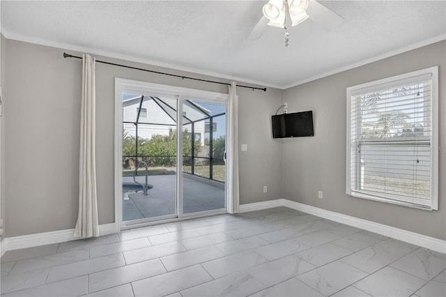 unfurnished room with ceiling fan, plenty of natural light, and ornamental molding