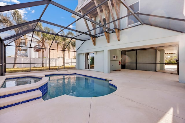 view of swimming pool with an in ground hot tub, a patio, and glass enclosure