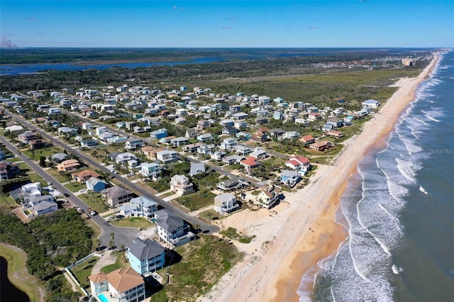 bird's eye view with a water view and a beach view