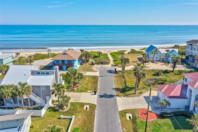 drone / aerial view with a beach view and a water view