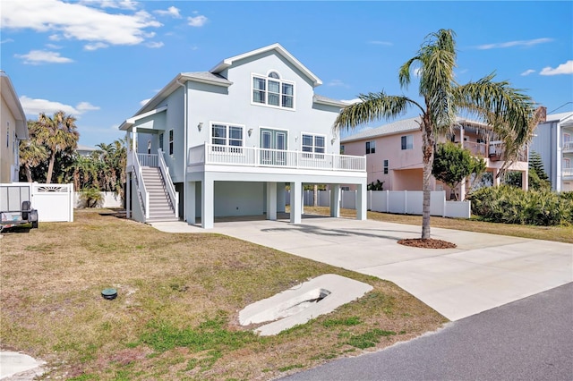 raised beach house with a carport and a front yard