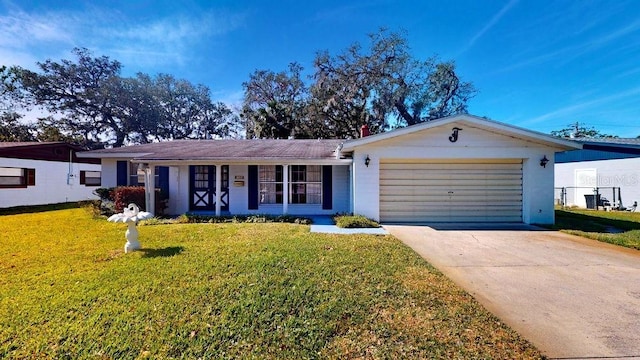 ranch-style home with a garage and a front yard