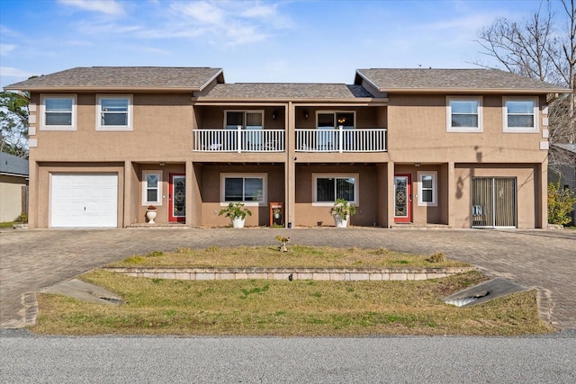 view of front of house with a garage and a balcony