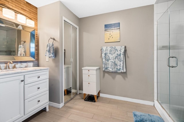 bathroom featuring vanity, a shower with shower door, and hardwood / wood-style floors