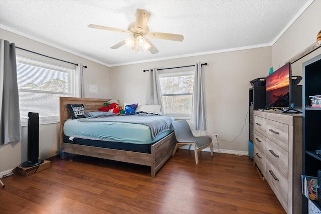 bedroom with dark wood-type flooring, ornamental molding, multiple windows, and a textured ceiling