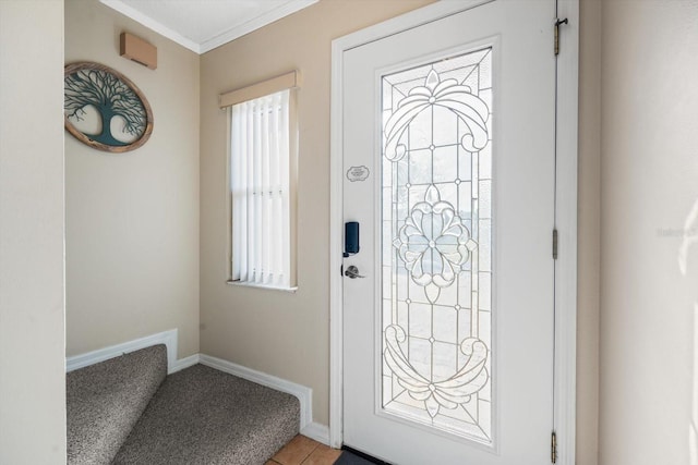 entryway with crown molding and light tile patterned flooring