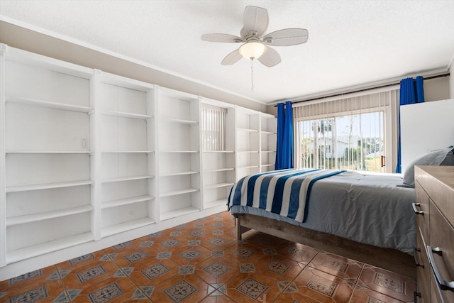 bedroom with ceiling fan and a textured ceiling