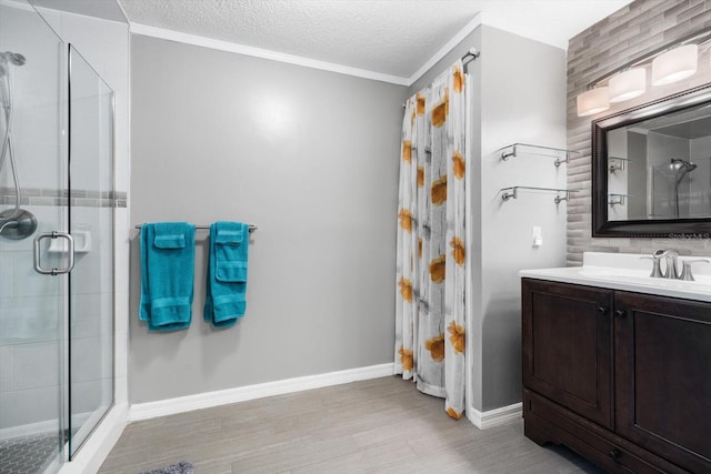 bathroom with vanity, an enclosed shower, wood-type flooring, and a textured ceiling