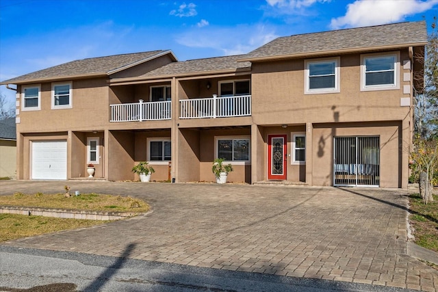 view of front of house featuring a garage and a balcony