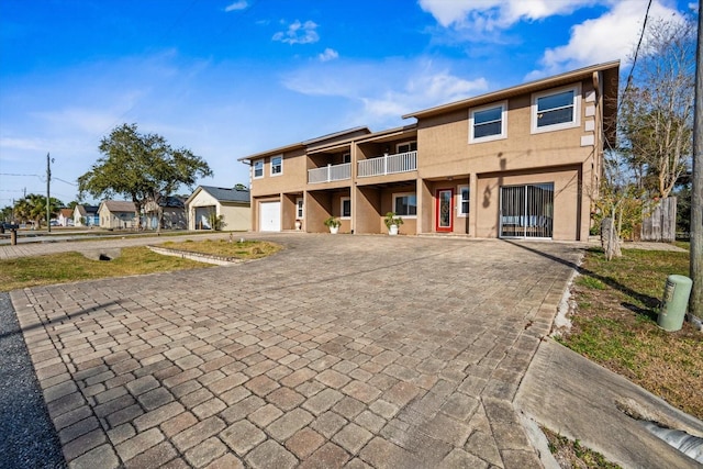 view of front of property with a garage and a balcony