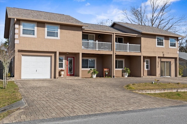 view of front of home featuring a garage and a balcony