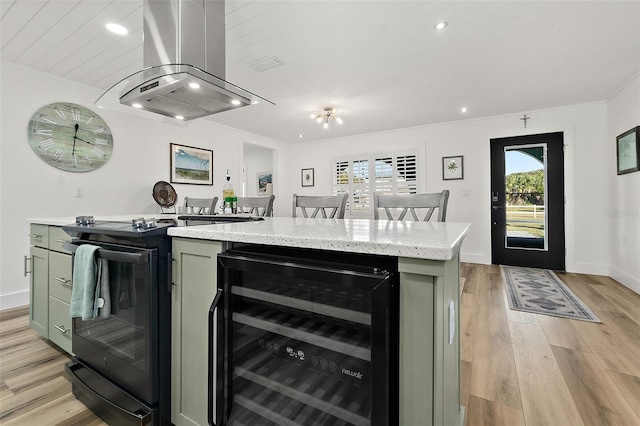 kitchen with wine cooler, crown molding, island range hood, a kitchen island, and black range with electric stovetop