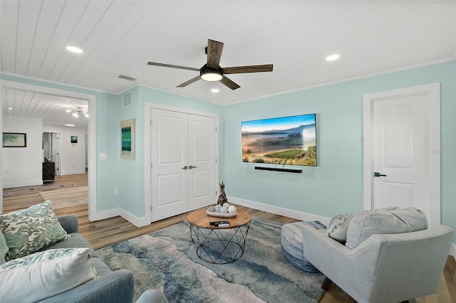 living room featuring crown molding, hardwood / wood-style flooring, wooden ceiling, and ceiling fan