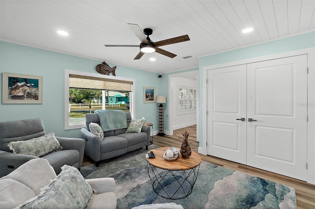 living room featuring wood-type flooring, wooden ceiling, and ceiling fan