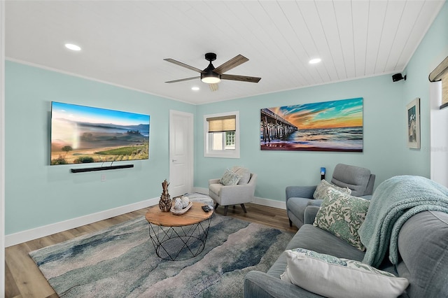 living room featuring ceiling fan, wood-type flooring, and wooden ceiling