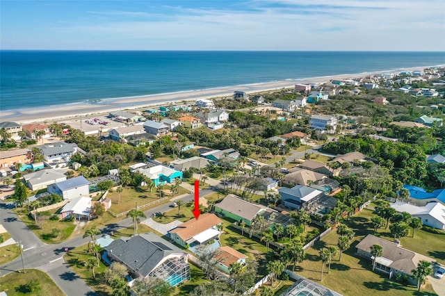 bird's eye view featuring a water view and a beach view