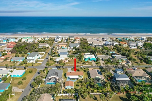 birds eye view of property featuring a view of the beach and a water view