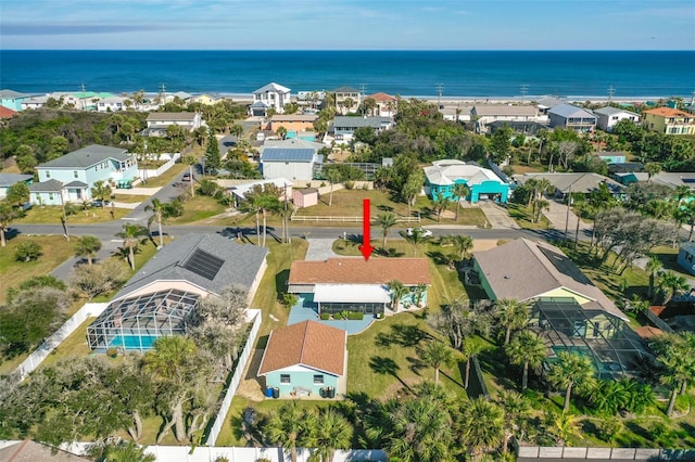 drone / aerial view with a water view and a residential view