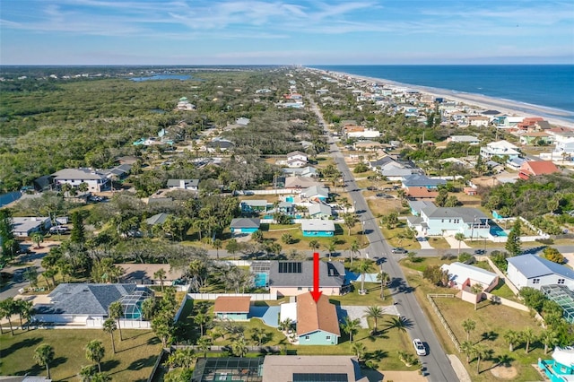 bird's eye view with a water view and a beach view