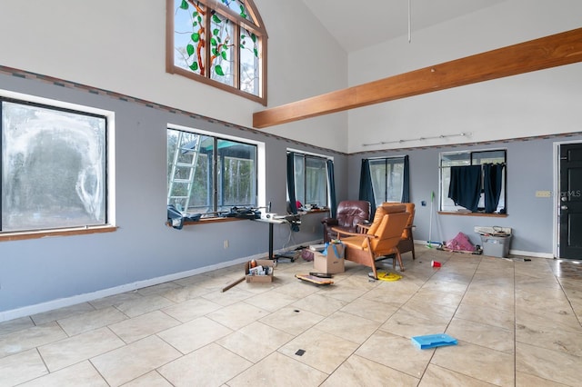 interior space featuring a towering ceiling and light tile patterned floors