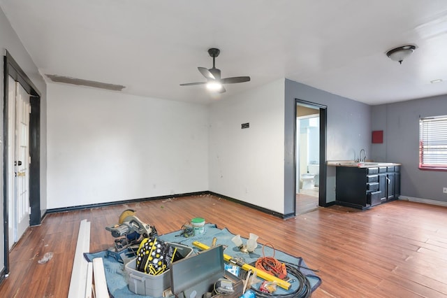 living room with wood-type flooring and ceiling fan