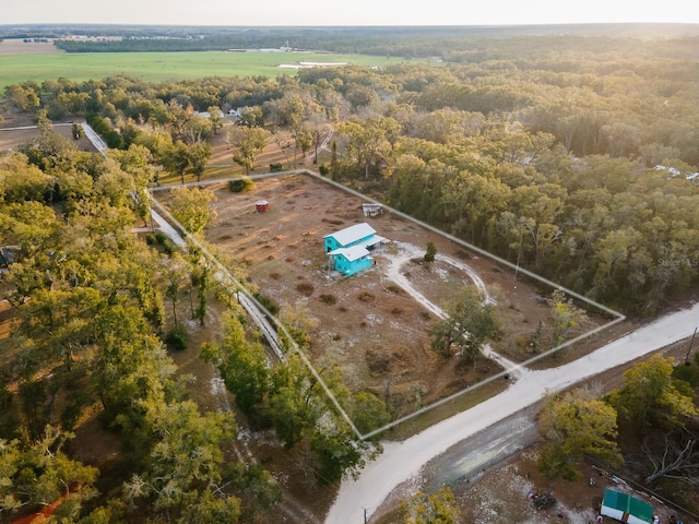 aerial view of property's location featuring a heavily wooded area and rural landscape