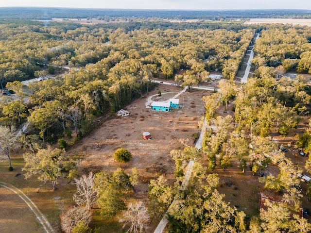 aerial overview of property's location with a heavily wooded area