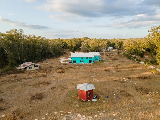 aerial view of sparsely populated area with a forest
