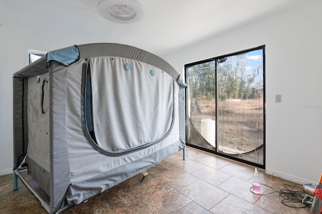 unfurnished bedroom with access to exterior and baseboards